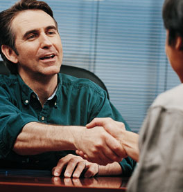 Dealer supporting customer and shacking hands in agreement